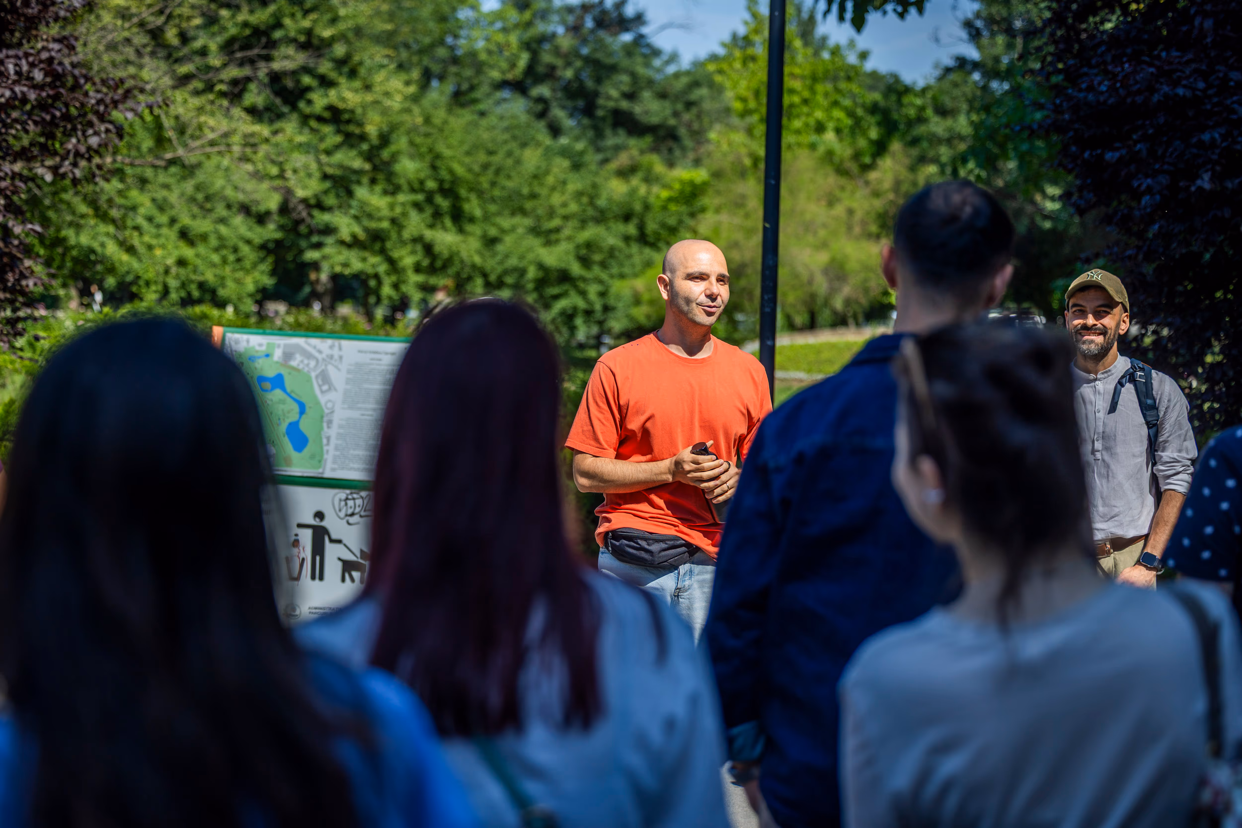 Endi Ungureanu speaks to the group in front of the park map board