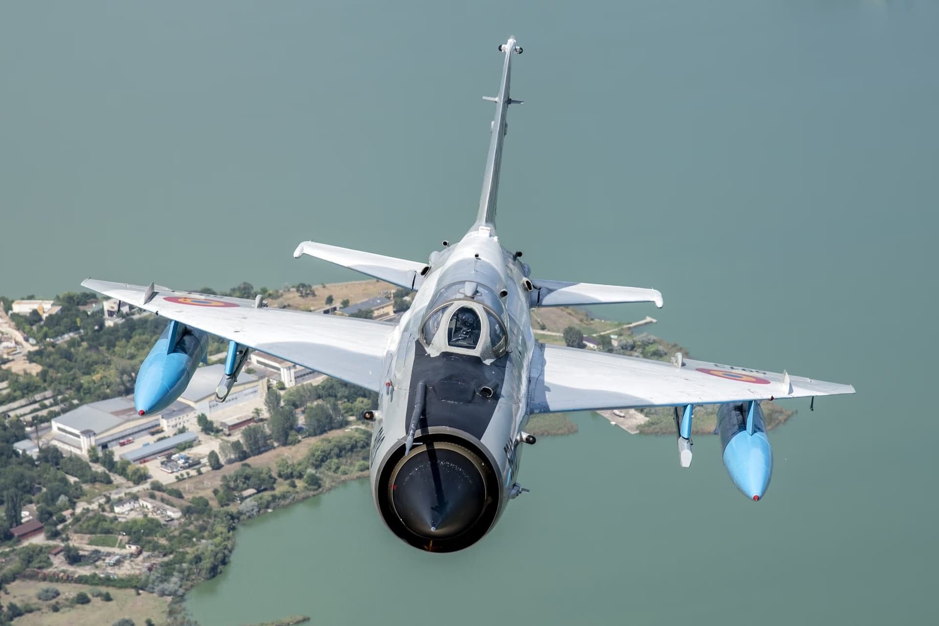MiG-21 LanceR — frontal view above a lake/pond