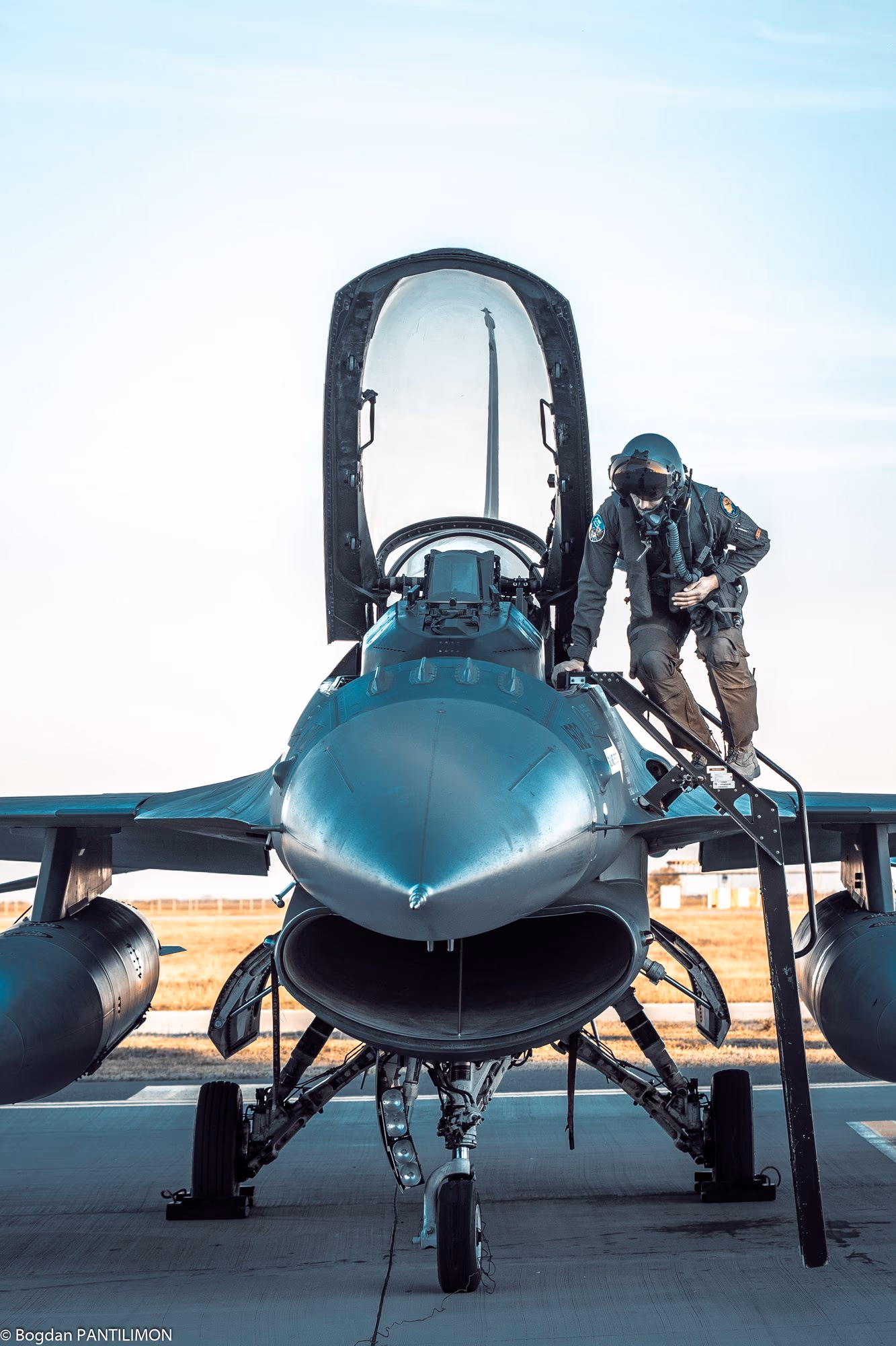 Pilóta a kifutón egy F-16 pilótafülkéjébe felmászva — közeli szembe nézet
