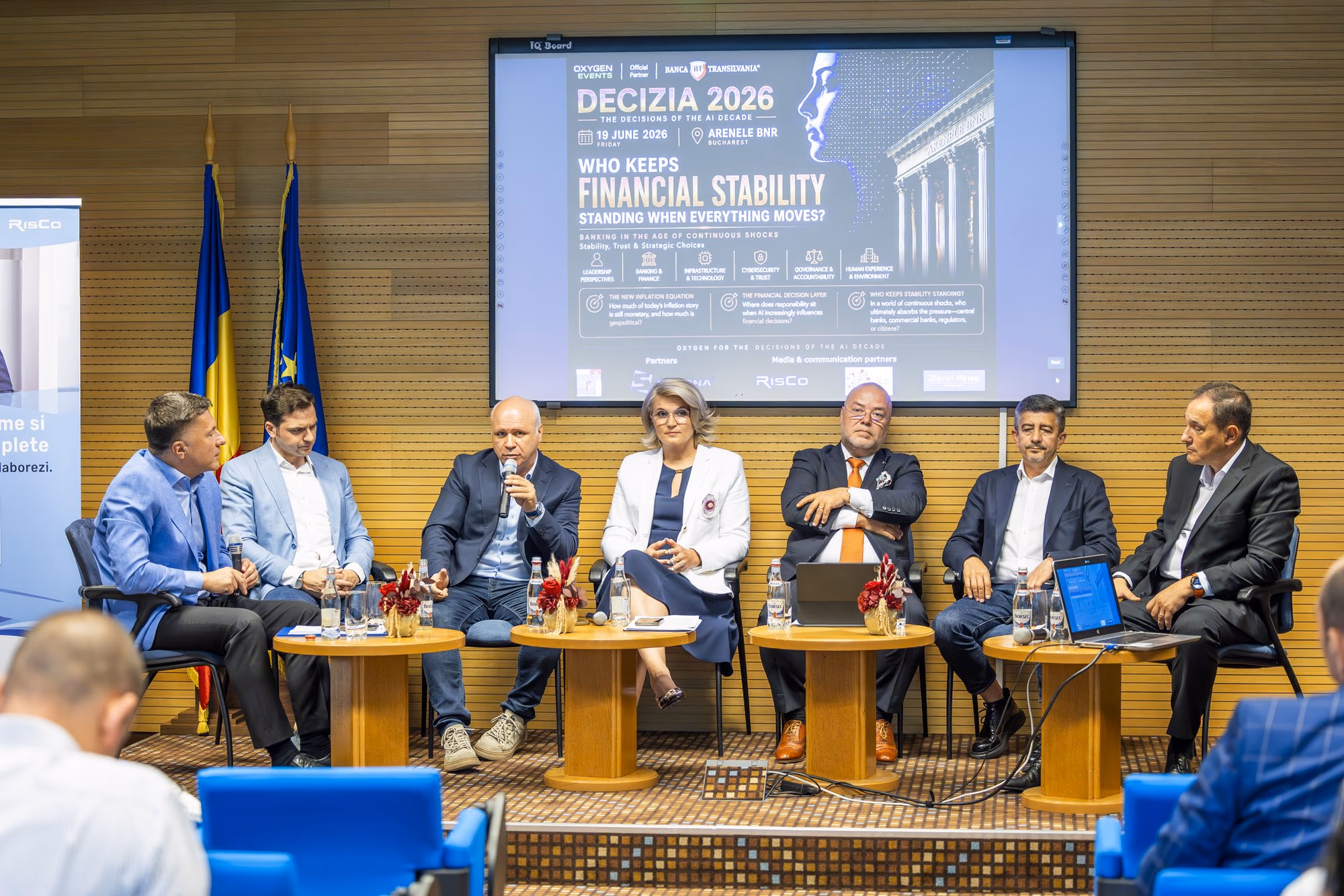 The Financial Stability panel — all seven panellists on stage, mid-distance view