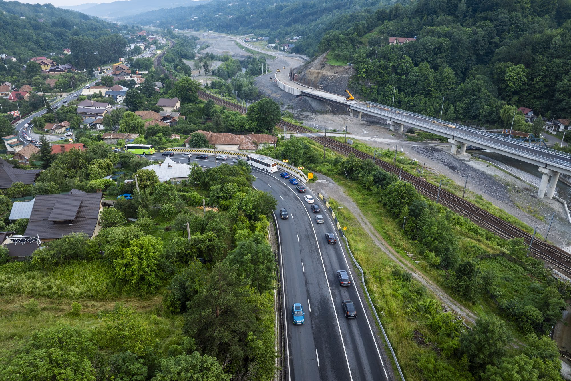 Aerial view of the Comarnic bypass — the new bridge on the right, traffic on DN1 heading to the coast in the centre-left