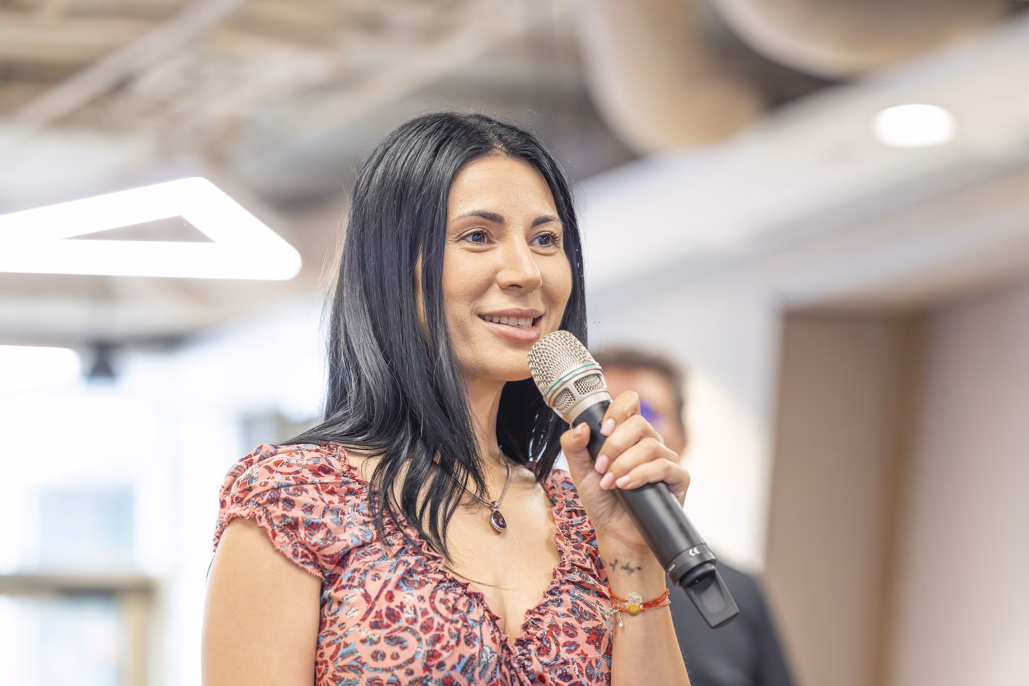 A woman from the audience asking a question during panel 4.