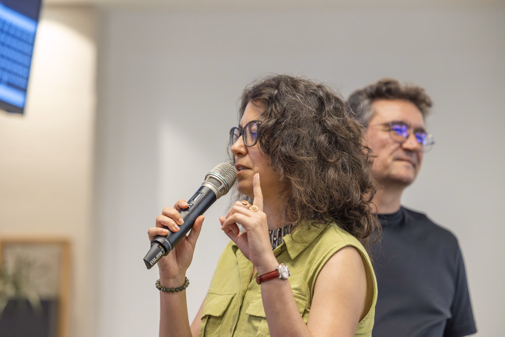 A woman from the audience asks a question during the first panel.