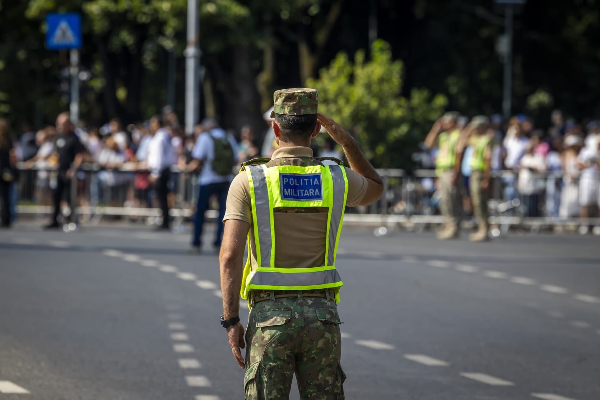 A military policeman salutes as the formation passes. Photo: AdiCoco.com