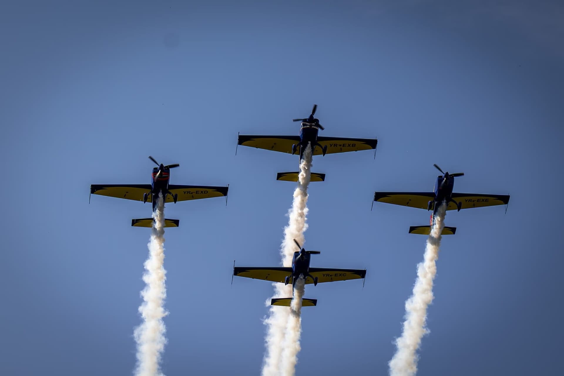 The Extra 300 formation, trailing white smoke. Photo: AdiCoco.com