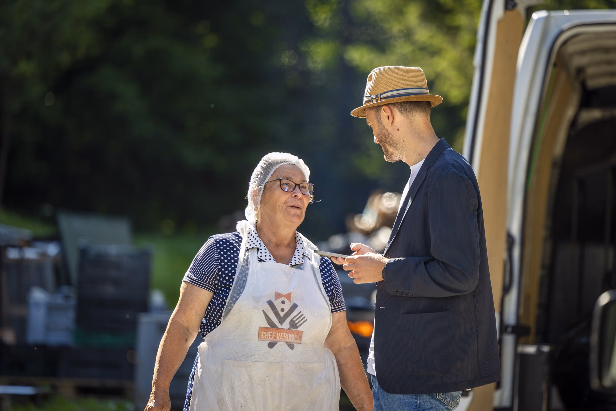 Veronica and Răzvan in conversation, beside the van