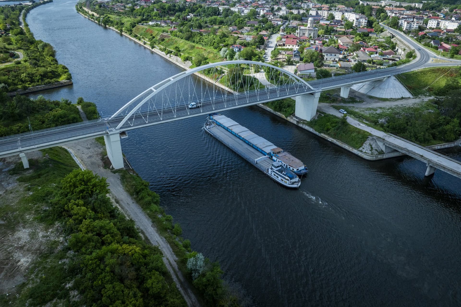 Barge beneath the bridge, with the town of Murfatlar behind