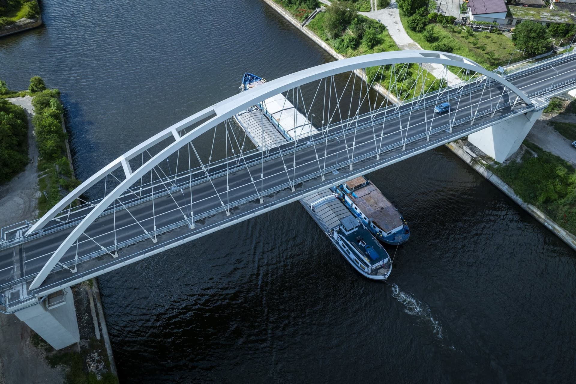 Barge passing beneath the deck, seen from above through the hangers