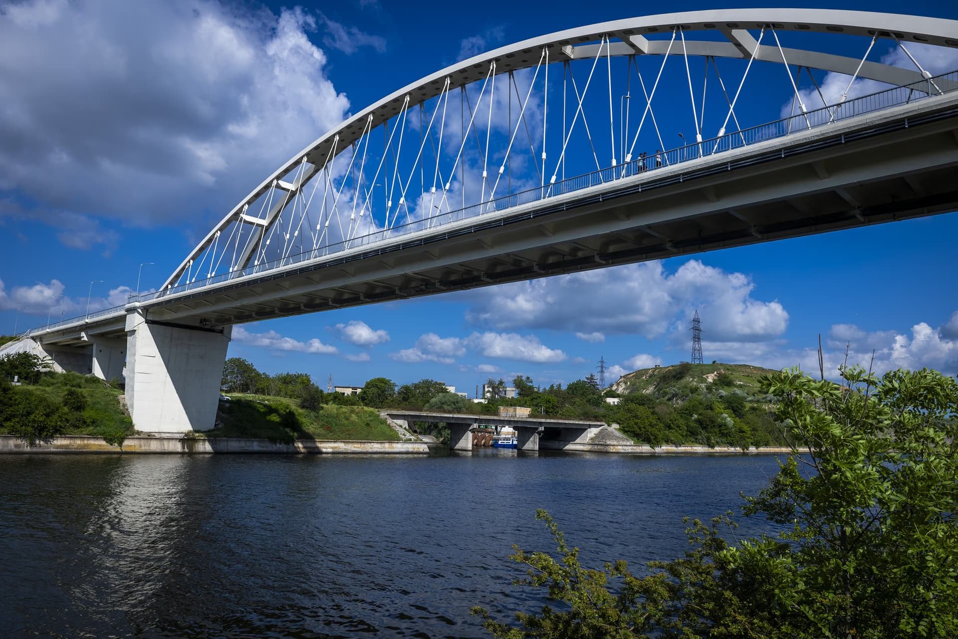 The bridge seen from the canal bank, across the water