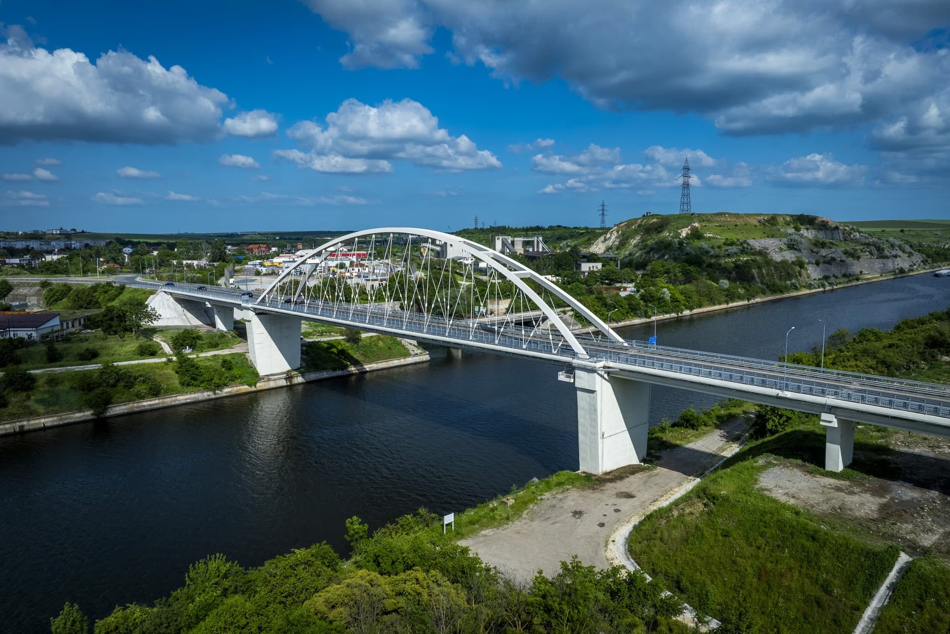 The bridge, the hilltop town and the limestone cliff, seen from a drone