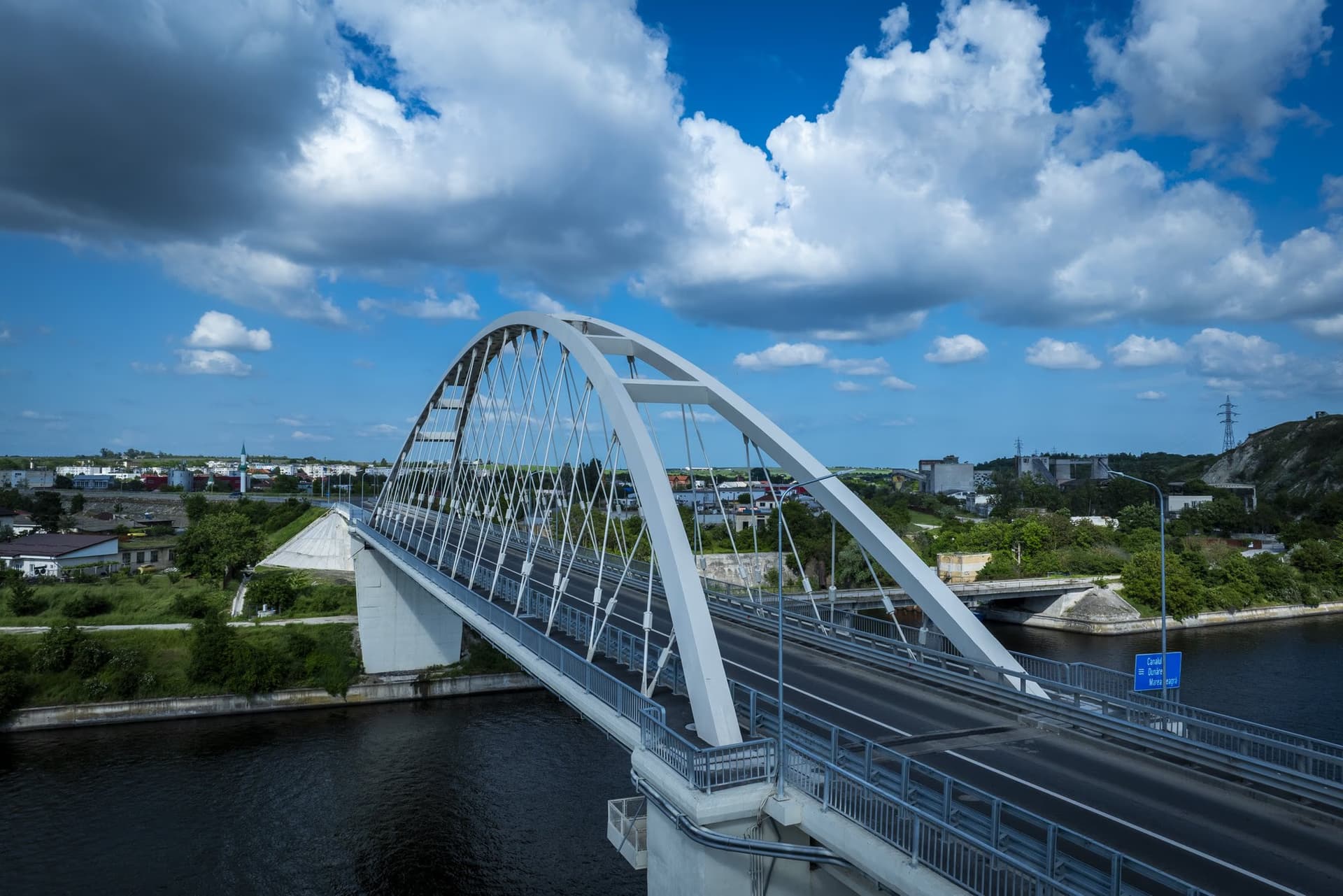 The bridge's full profile, with both viaducts, against a clouded sky
