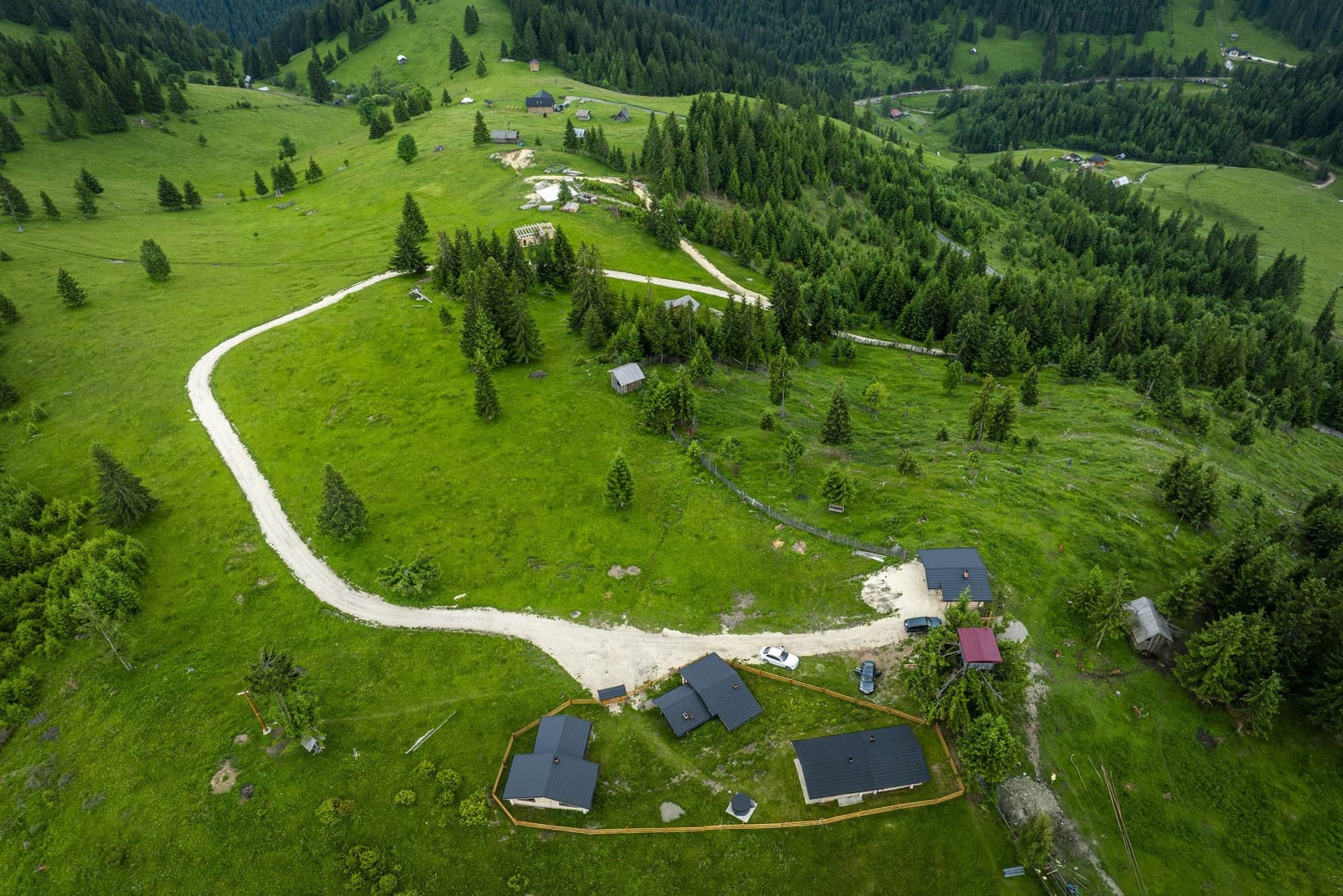 A farm egészen magasról, a tisztáson átívelő fehér út hurkával