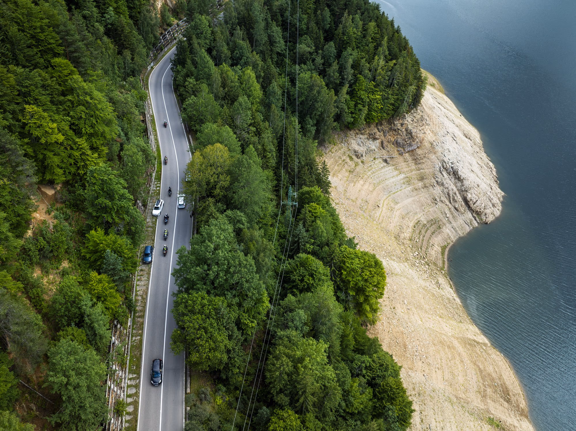 The Transfăgărășan winding along the shore of Lake Vidraru, seen from a drone