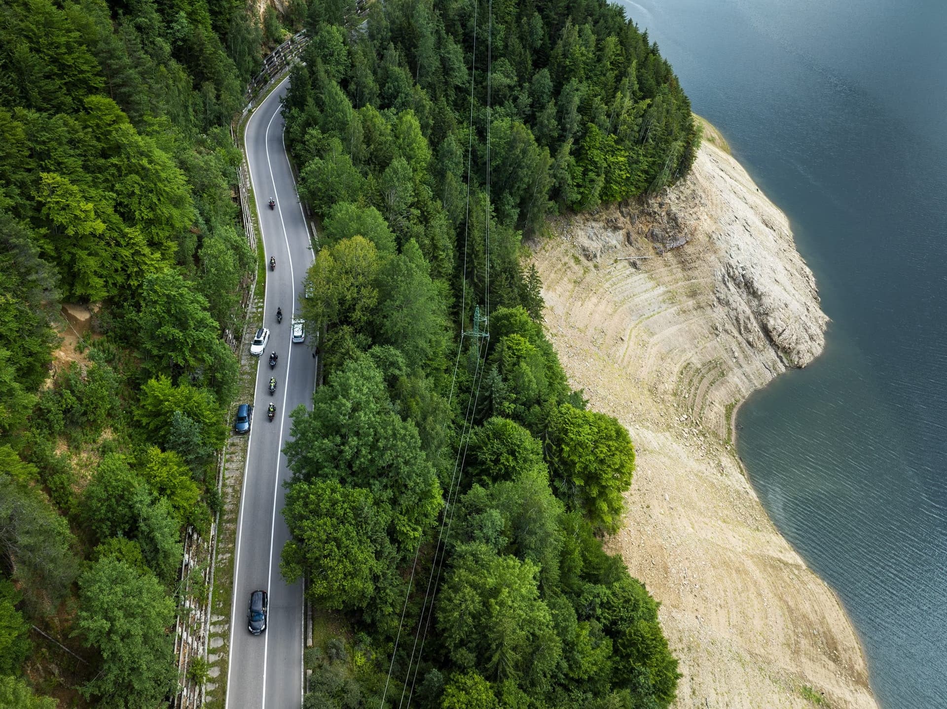 The Transfăgărășan winding along the shore of Lake Vidraru, seen from a drone
