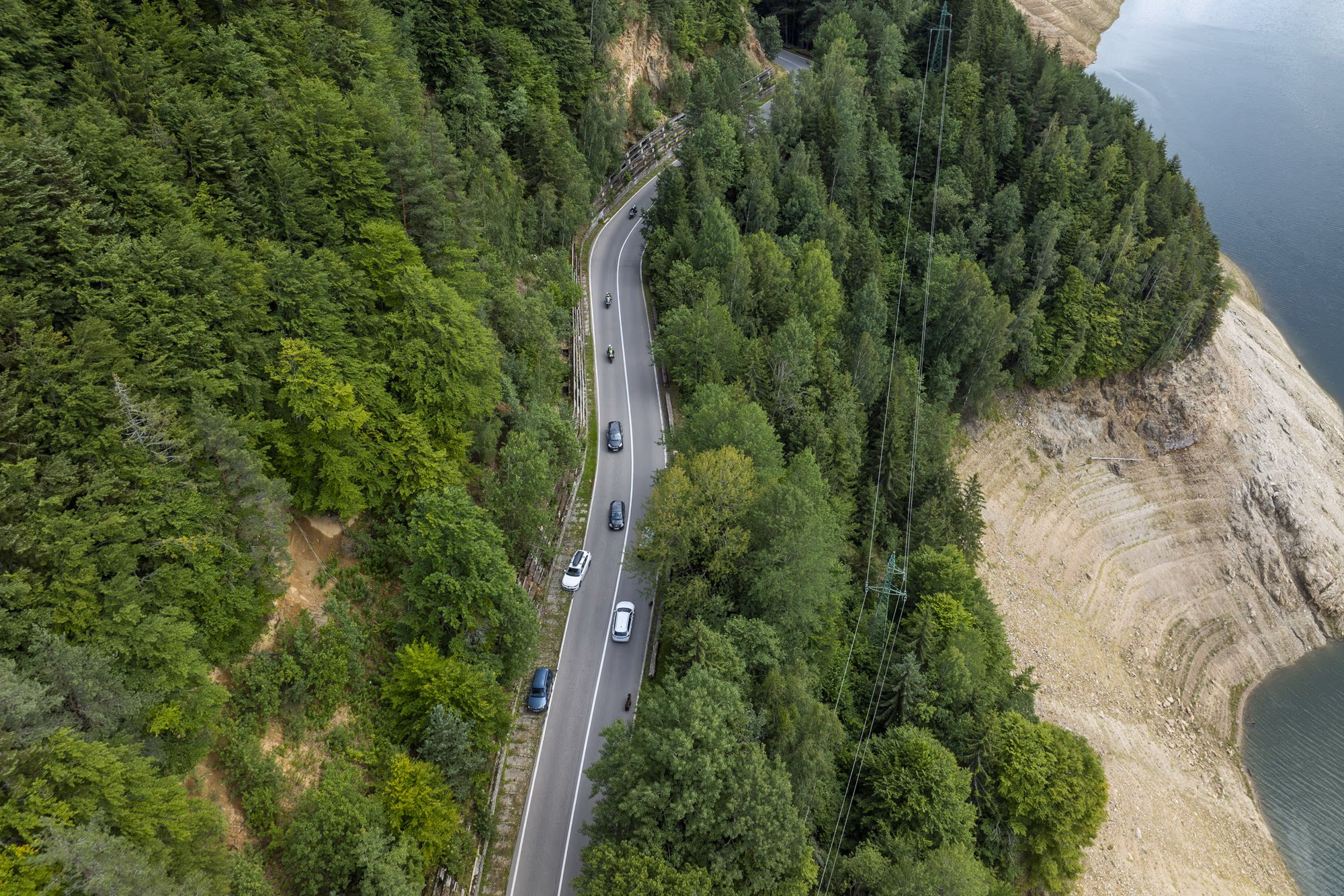 Cars on the Transfăgărășan, above the exposed shore of Lake Vidraru