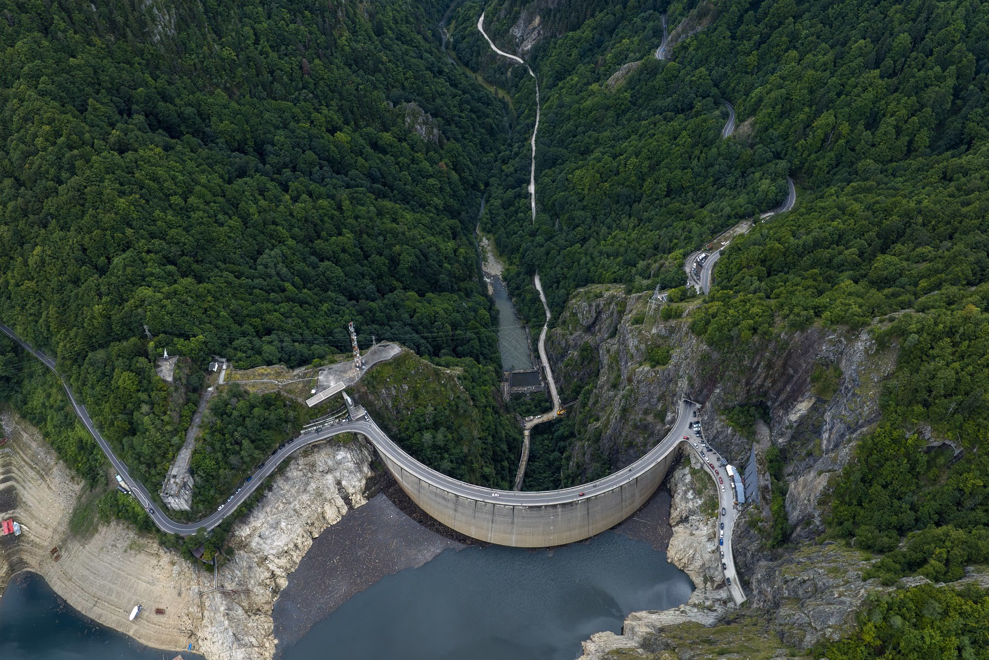 Vidraru dam, the concrete arch between two limestone walls, with the road crossing its crest