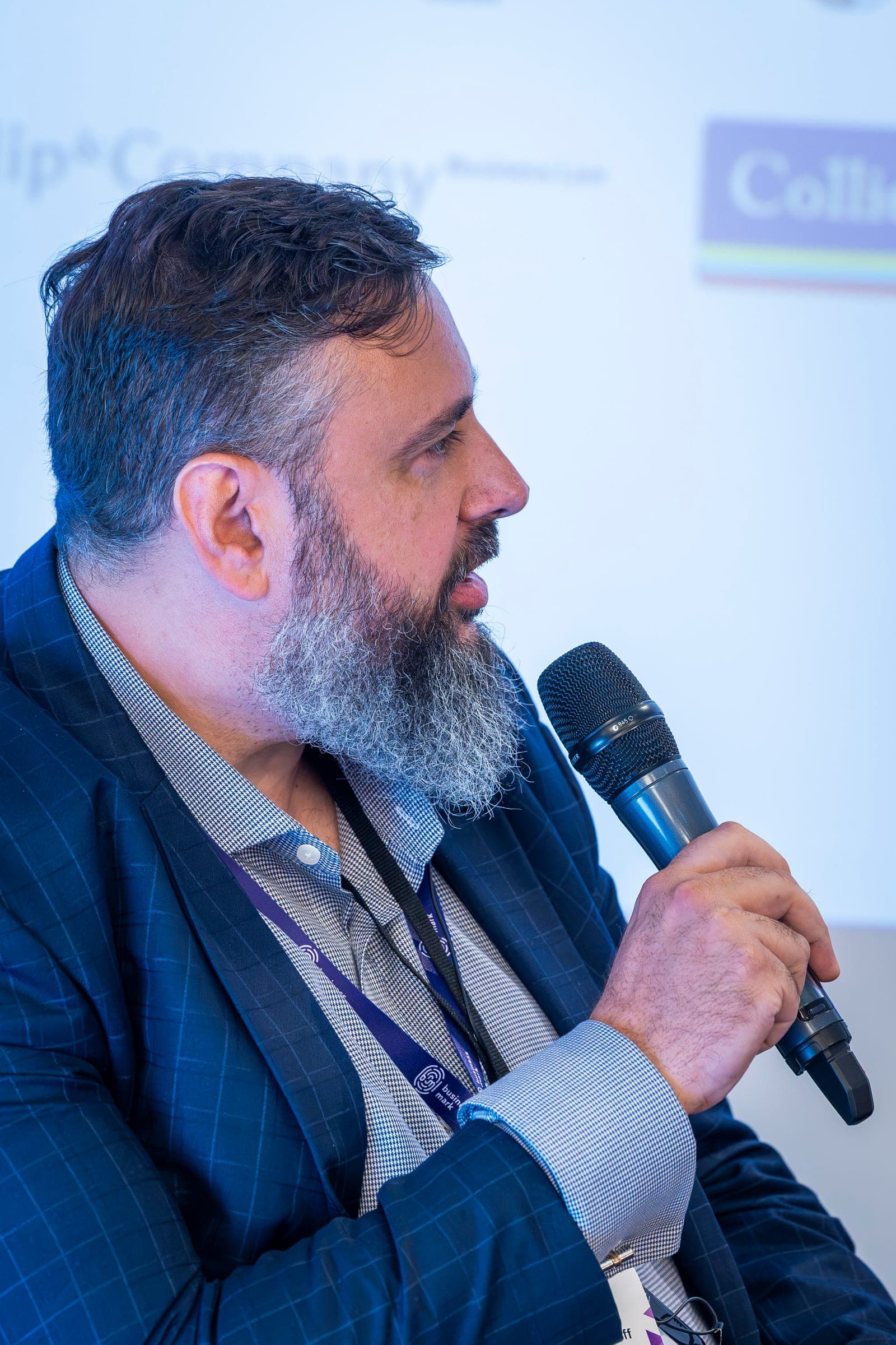 Vladimir Gurdjieff, grey-bearded, at the microphone