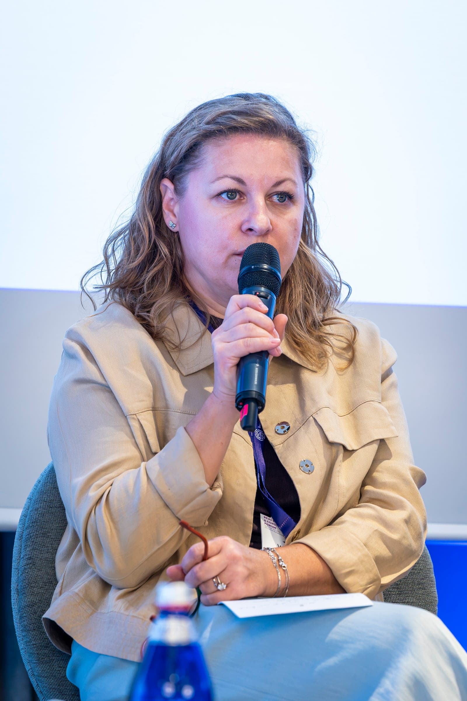 Venera Munjev speaking into a microphone during the first panel