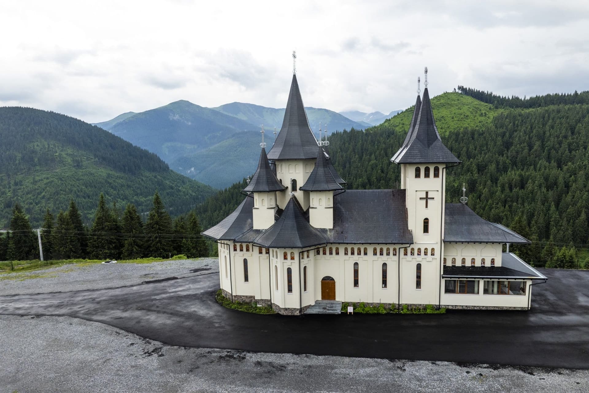 The masonry church of the Prislop Monastery, with pointed spires, on the saddle of the pass