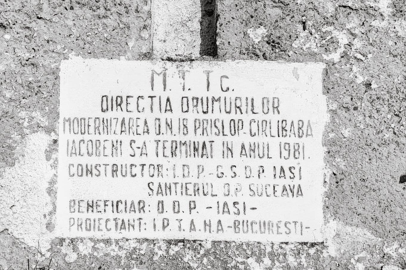 The white plaque on the Prislop Pass obelisk, recording the completion of the DN18 modernisation in 1981