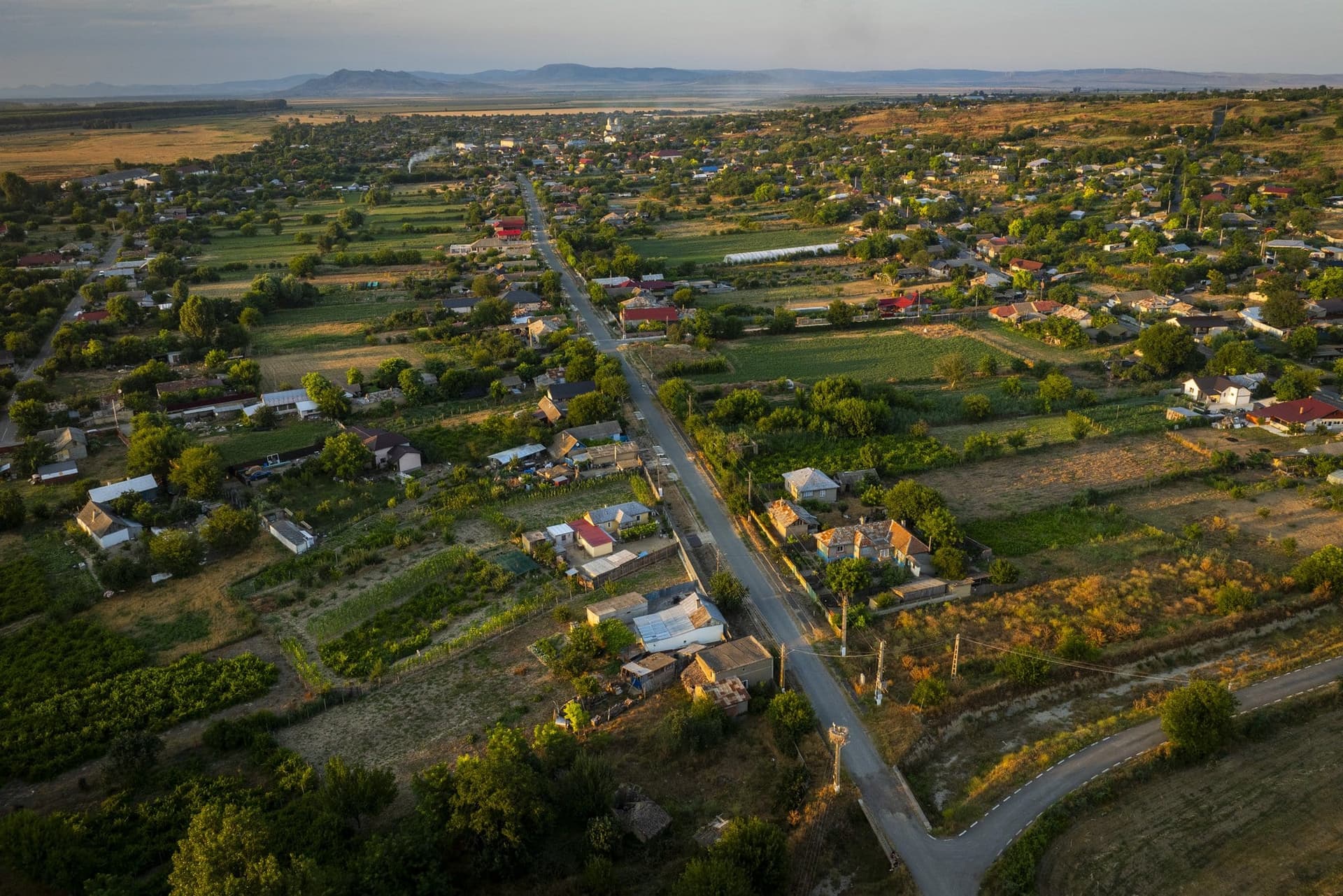 Peceneaga seen from a drone, between bare hills and the Danube floodplain